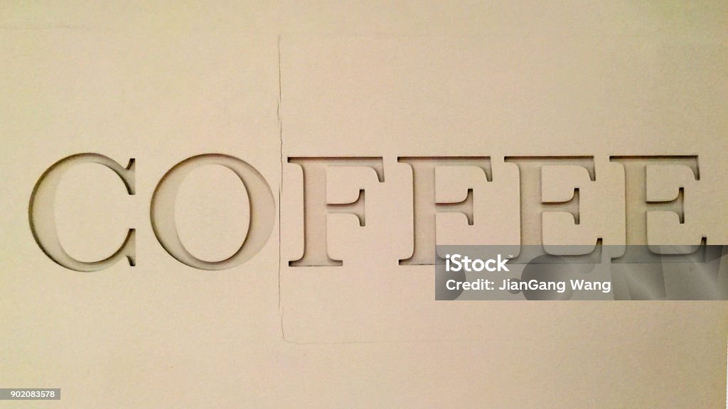 "COFFEE" sign on beige wall Capital letter single word on the wall Beige Stock Photo