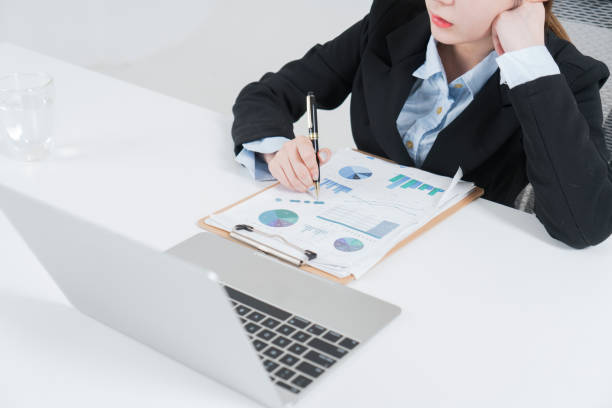 istock businesswoman writing reports on desk 902084078