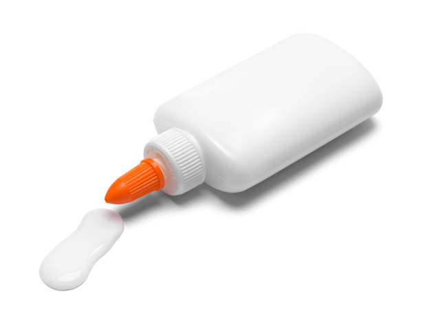 Glue Bottle Spilling Spilling Bottle of Glue Isolated on White. solvent stock pictures, royalty-free photos & images