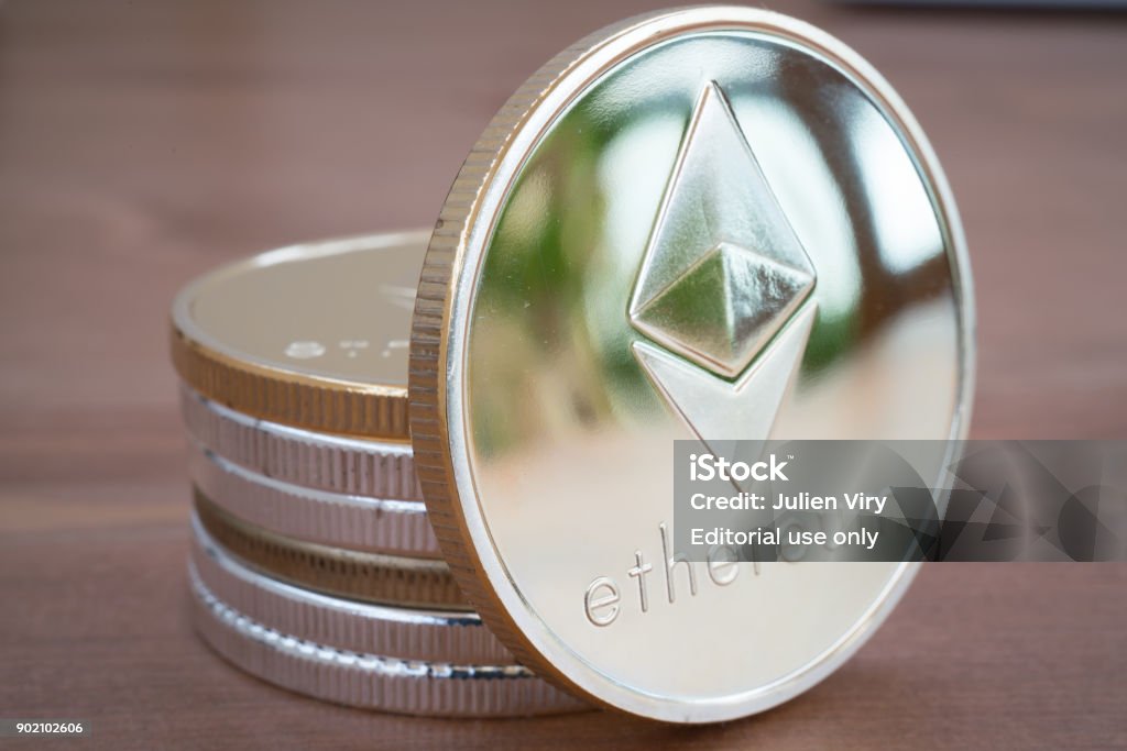 Pile of Coin of Silver Ethereum on wooden background Pile of Real coin of cryptocurrency Silver Ethereum on wooden background Blockchain Stock Photo