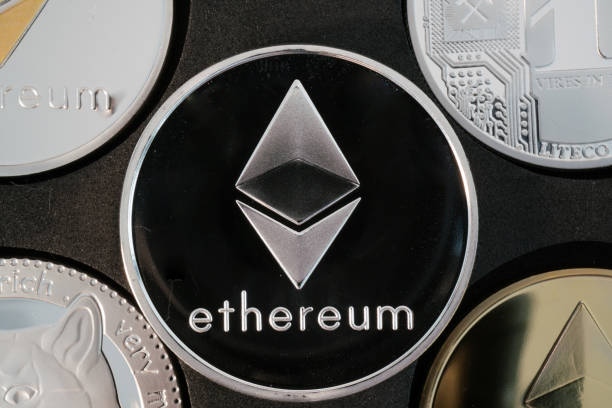 Ethereum cryptocurrency real silver coin closeup Ethereum cryptocurrency real silver coin in middle of other crypto closeup ethereum stock pictures, royalty-free photos & images