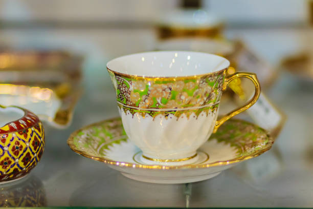 istock Vintage Thai's style porcelain coffee cup handmade. Beautiful traditional Thai five-colored porcelain ceramic coffee cup. Benjarong Porcelain coffee cup for sale in the flea market, Thailand. 902112722