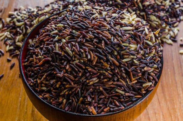 istock brown rice in wooden bowl 902120830