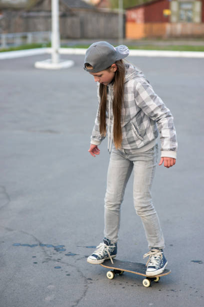 istock child girl on skateboard 902123758