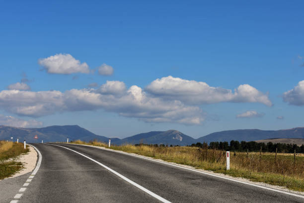 istock An open road through beautiful countryside 902124552