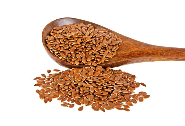 istock Flax seeds in wooden spoon isolated on white background 902128210
