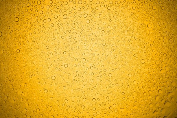 istock Water drops on yellow glass, Rain droplets on glass background. 902128304