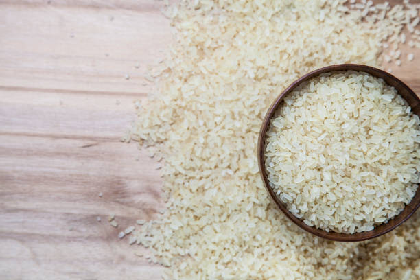 istock Raw rice in a wooden bowl 902133612
