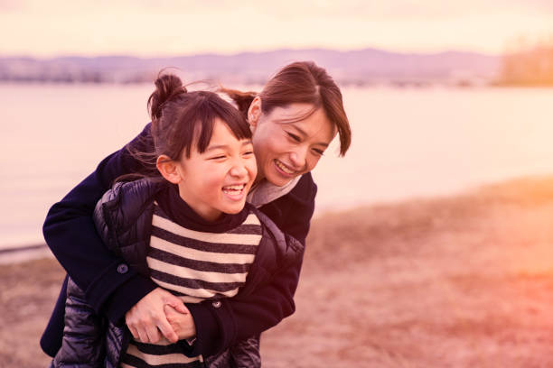 istock Mother having a good time with daughter in lake side park 902136792