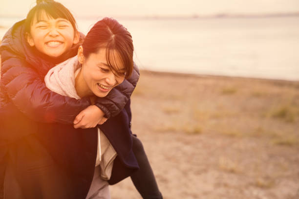 istock Mother having a good time with daughter in lake side park 902136836