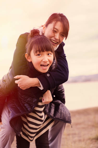 istock Mother having a good time with daughter in lake side park 902136854