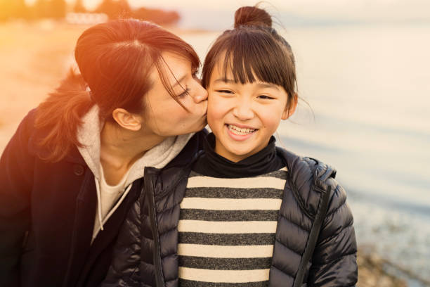 istock Mother having a good time with daughter in lake side park 902136856