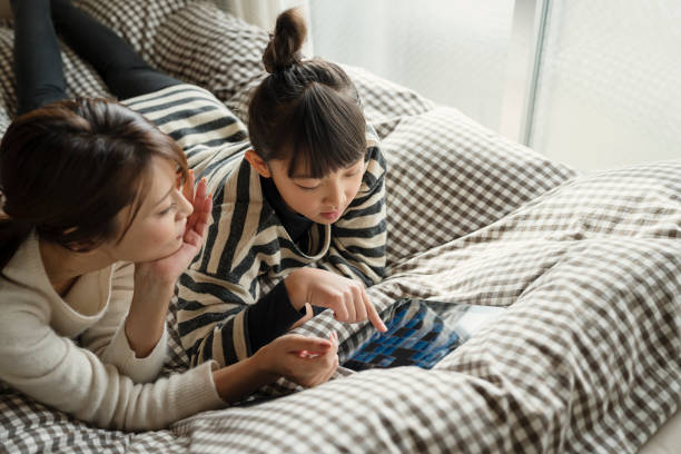 istock Mother and daughter relax at home 902136884