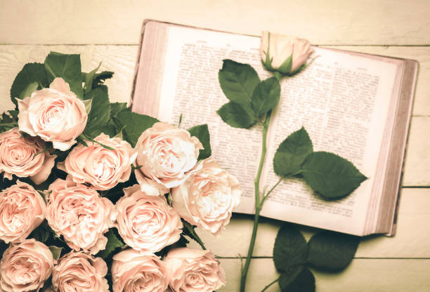 istock Roses bouquet and an open book in retro style 902140614