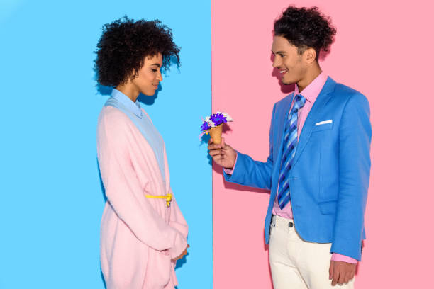 istock man presenting flowers to attractive african woman 902141996