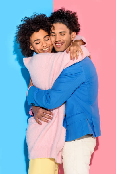 istock couple hugging each other on pink and blue background 902144336