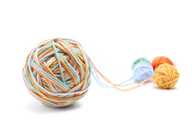 istock Colorful big thread ball from four color thread. Cotton thread balls isolated on white background. 902144370