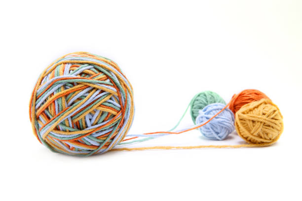 istock Colorful big thread ball from four color thread. Cotton thread balls isolated on white background. 902144498