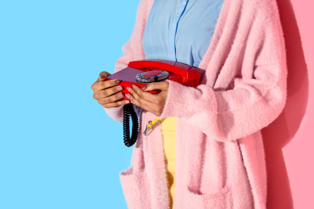 istock woman holding retro telephone in hands 902144604
