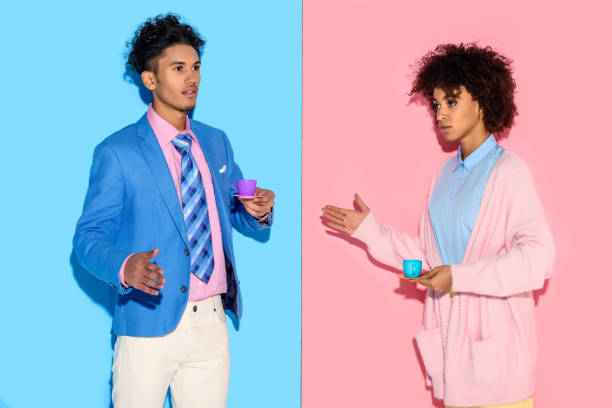 istock couple with toy teacups with pink and blue wall backdrop 902144820