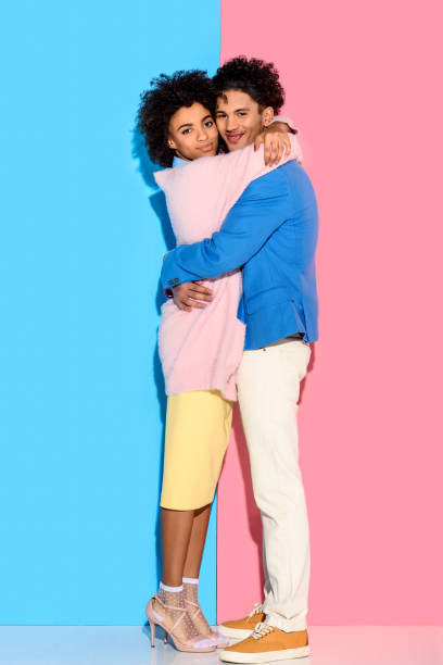 istock couple hugging each other on pink and blue background 902144990