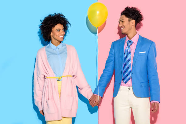 istock couple holding hands with air balloon 902145436