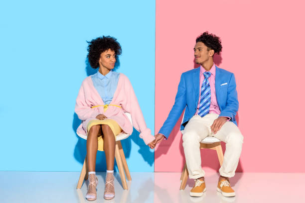 istock couple holding hands while sitting on chairs 902145602