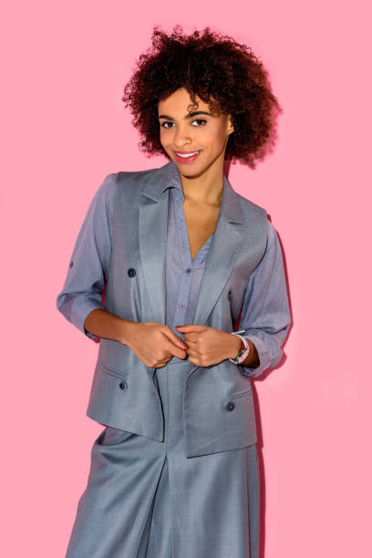 istock girl in grey suit on pink background 902148794