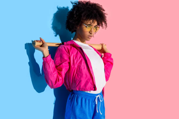 istock girl with baseball bat on her shoulders 902148854