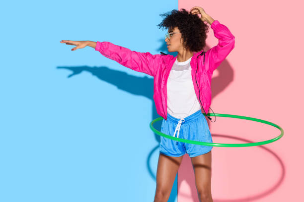 istock Sporty woman posing while exersizing with hoop 902149192