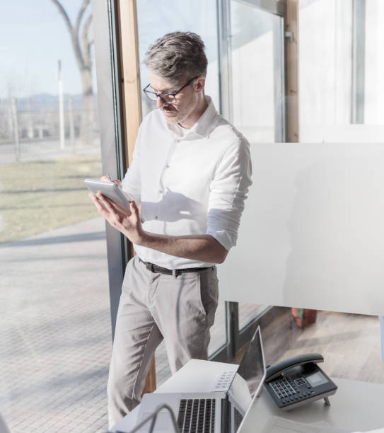 istock Businessman using his tablet in the office 902152600