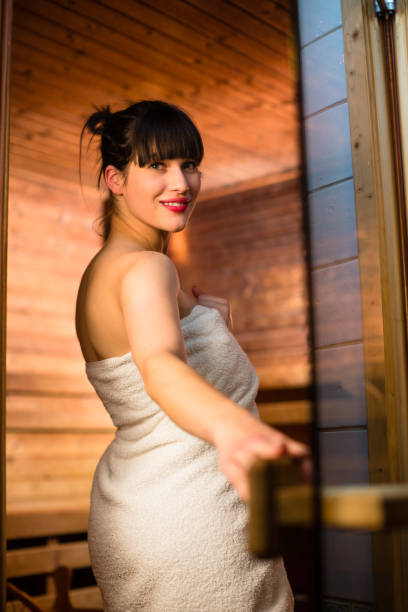 istock Young woman relaxing in a sauna, 902156114