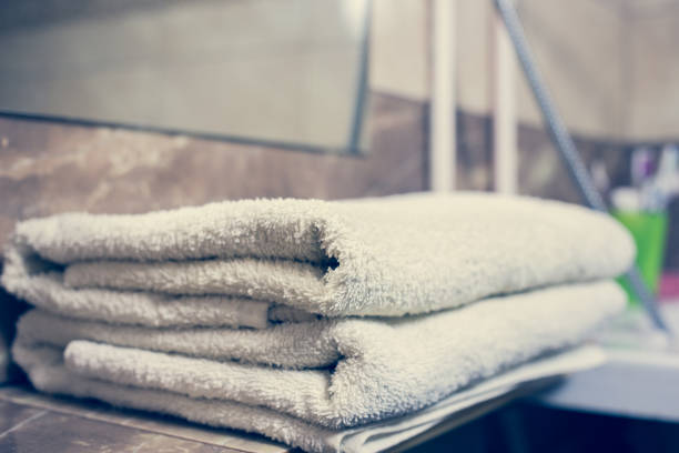 istock Blurred bathroom interior background and white spa towels on Marble 902157502