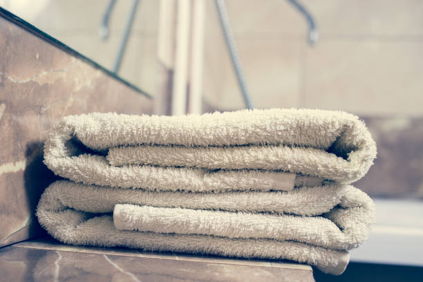 istock Blurred bathroom interior background and white spa towels on Marble 902160108