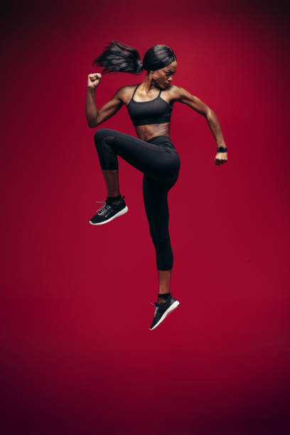 istock Healthy african woman jumping and exercising 902161002