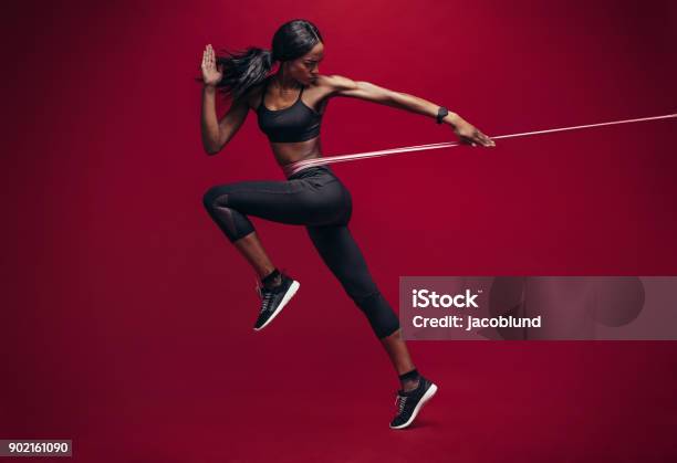Sporty Woman Exercising With Resistance Band Stock Photo - Download Image Now - Resistance Band, Exercising, Women