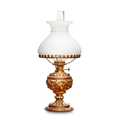 Vintage table lamp with white lampshade isolated on white background. Antique oil lamp. Single object with clipping path