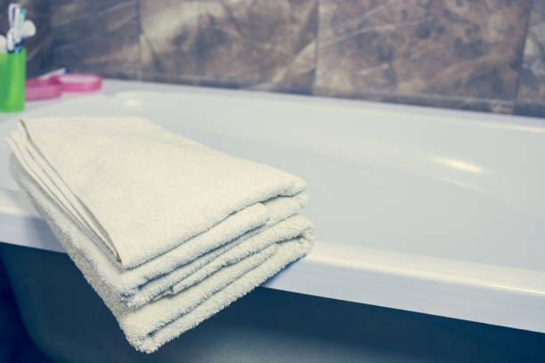 istock Blurred bathroom interior background and white spa towels on Marble 902161200