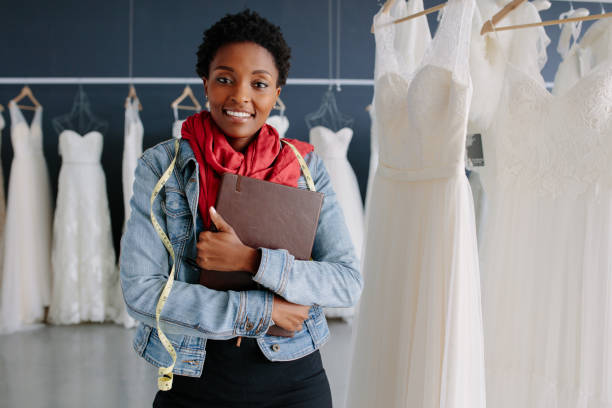 istock Wedding dress store owner with a diary 902164908