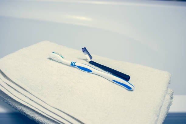 istock Blurred bathroom interior background and white spa towels on Marble Toothbrush razor 902167142