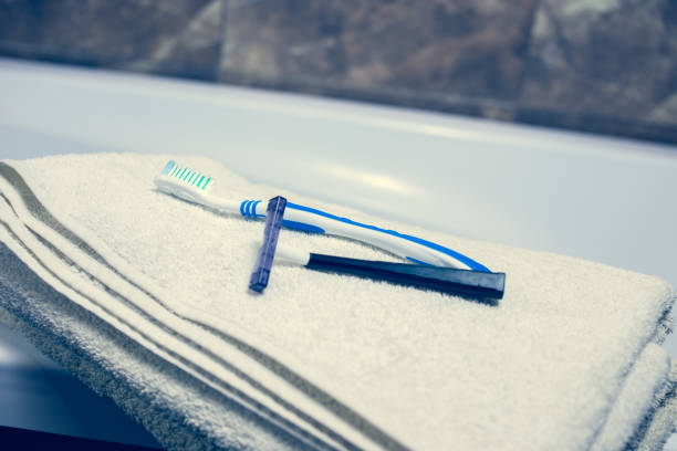 istock Blurred bathroom interior background and white spa towels on Marble Toothbrush razor 902167272