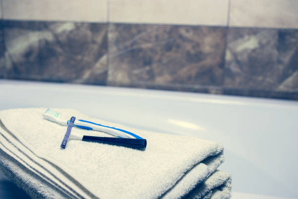 istock Blurred bathroom interior background and white spa towels on Marble Toothbrush razor 902167358