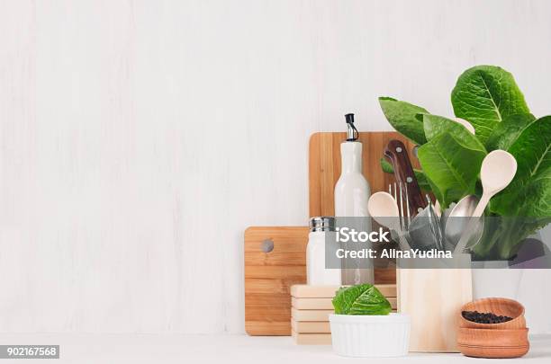 Natural Beige And Brown Wooden Kitchenware And Green Plant On Light White Wood Background Copy Space Stock Photo - Download Image Now
