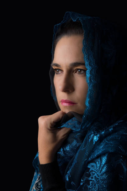 istock Middle Eastern woman portrait looking sad with a blue hijab artistic conversion 902167786