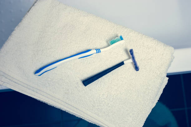 istock Blurred bathroom interior background and white spa towels on Marble Toothbrush razor 902168040