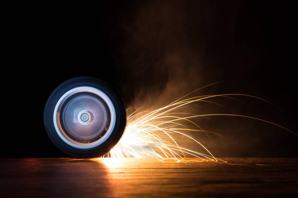 Toy wheel spinning on black background with many sparks flying
