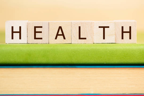 istock health word built with letter cubes on green book 902171548
