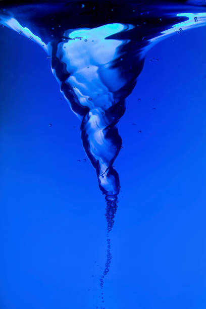 istock Blue water spiral of water swirling around in a studio 902172008