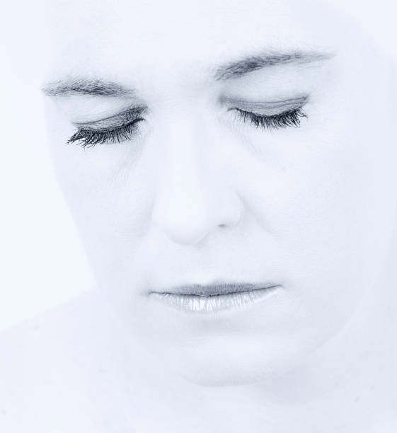 istock High key portrait of a woman with an empty expression on her face 902172486