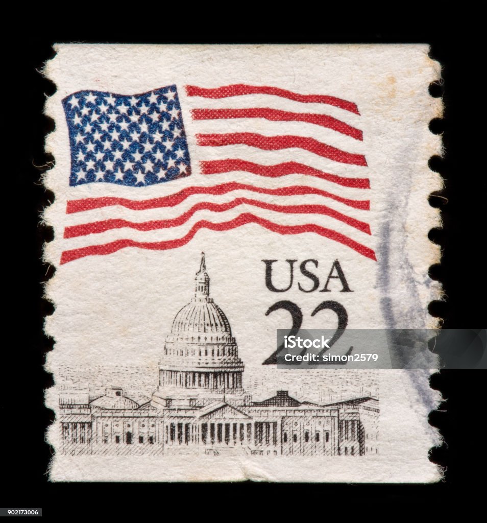 US Postage Stamp Stamp US Flag Over State Capitol building with black background. Postage Stamp Stock Photo